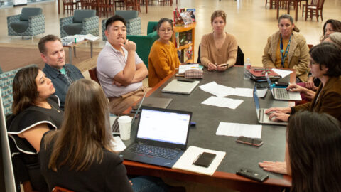 A group of teachers sitting around a table.