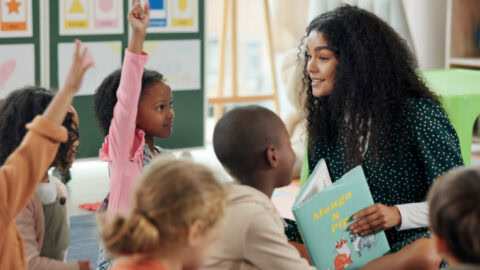 A teacher reading to a classroom of children.