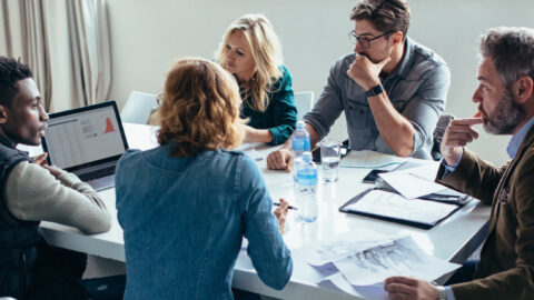 A group of professionals sitting at a conference table