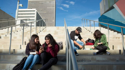 young people sitting on steps outdoors, talking