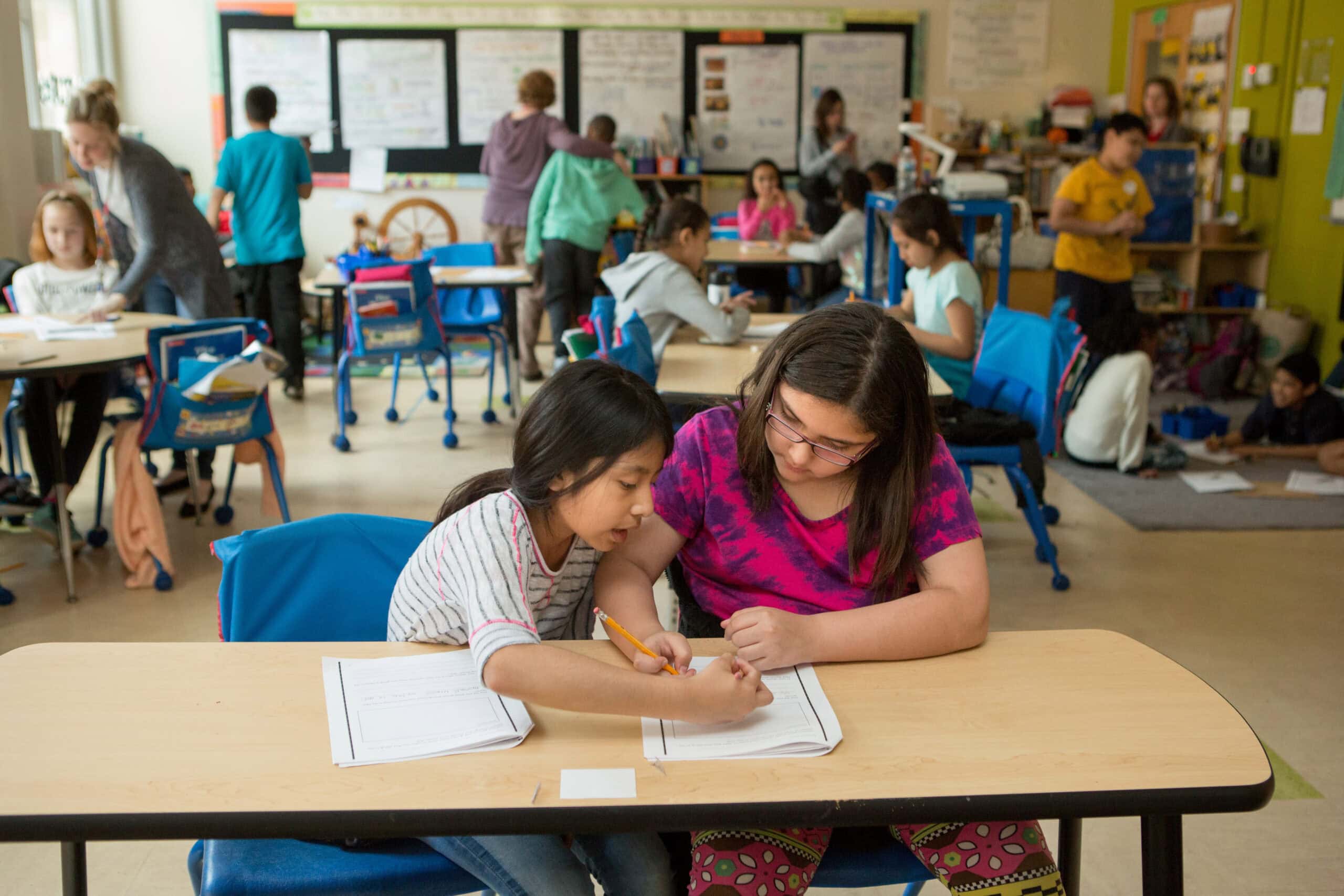 Fourth graders work together in a classroom.