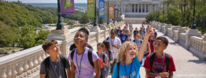 Children outdoors in front of a government building.